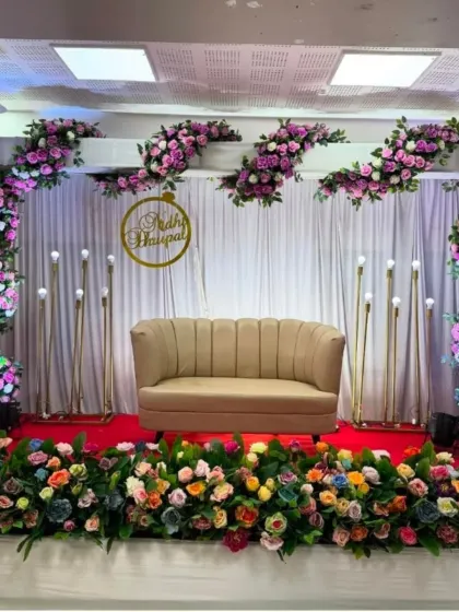 A closer view of the stage, showing the vibrant mix of flowers and the elegant lighting arrangement.