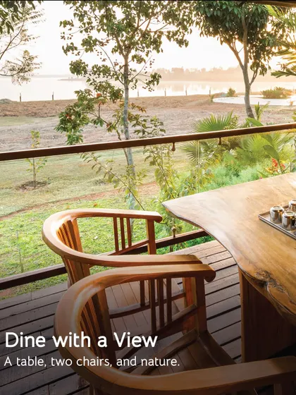 Dine with a view. This table for two on a private deck overlooking the water is the perfect spot for a quiet, scenic meal.