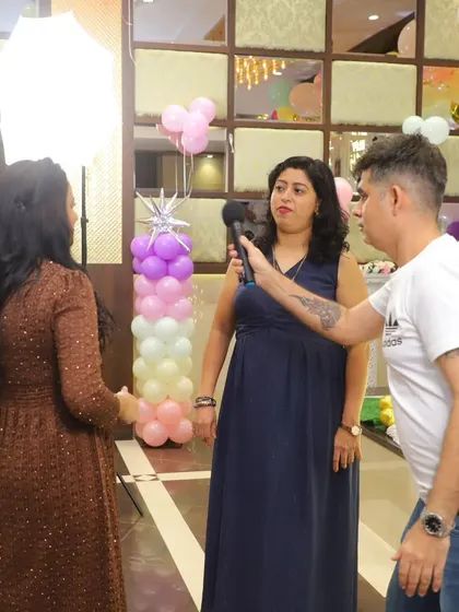 Getting the parents involved is part of the fun! Here I am interviewing a guest at a birthday party.