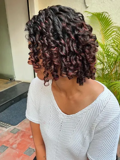 The red tones make her curls pop.