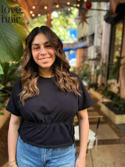 A happy client with her sun-kissed brown balayage, perfect for a natural, beachy vibe.