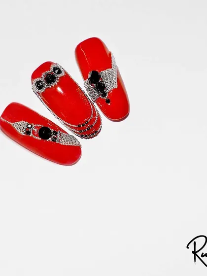 Another view of the red and black crystal jewelry design, showing the level of detail and precision required for this kind of work.