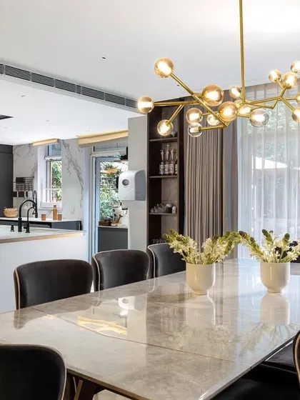 An open-plan kitchen and dining area in the Amara project. The design allows for seamless entertaining, with a large island kitchen flowing directly into the formal dining space.