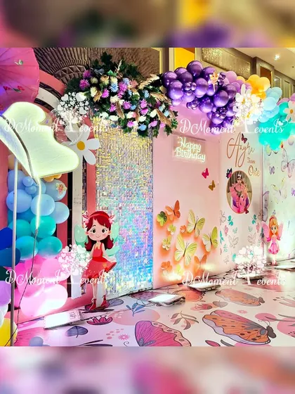 A closer look at the fairy and butterfly stage, showing the custom printed floor and the mix of 3D props that create a whimsical scene.