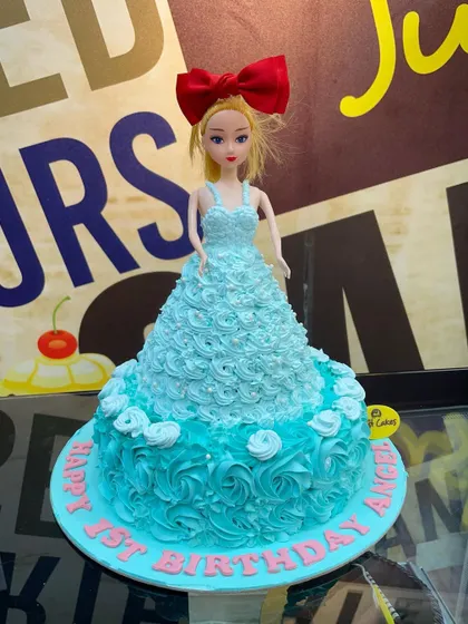 A lovely 2kg Barbie doll cake with a dress made of piped turquoise rosettes.