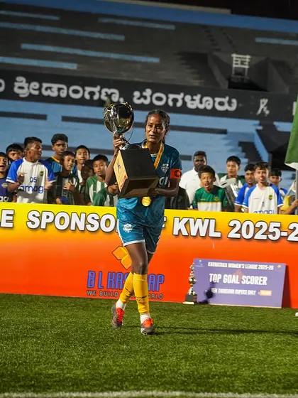 A champion's walk of honor. Our team captain carries the trophy past cheering young fans, inspiring the next generation of footballers.