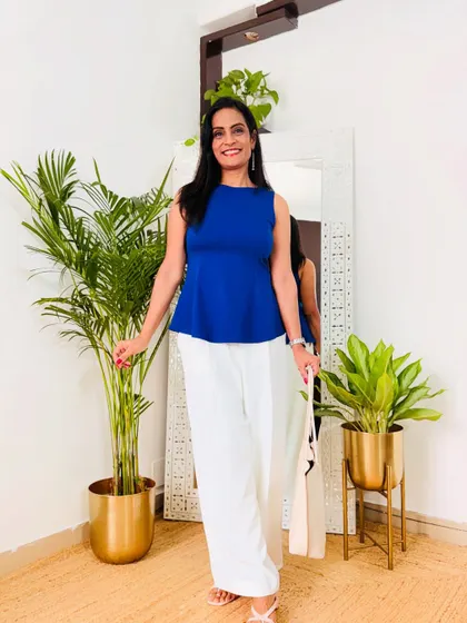 A vibrant blue peplum top paired with white trousers. This is a fresh and stylish combination, perfect for a summer work day.