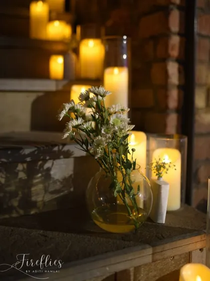 A close-up of a small floral arrangement and candles on a wooden staircase, showing how even small corners can be made beautiful.