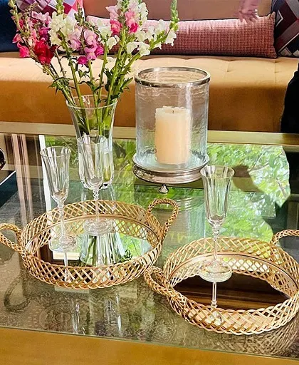 Our gold mirror trays, shown here in a living room setting, are perfect for serving drinks and lifting the aesthetic of any evening.