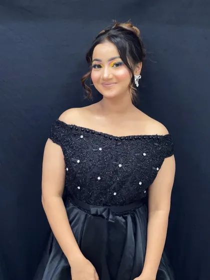The full party ensemble, with a focus on the colorful eye makeup and off-the-shoulder black gown.
