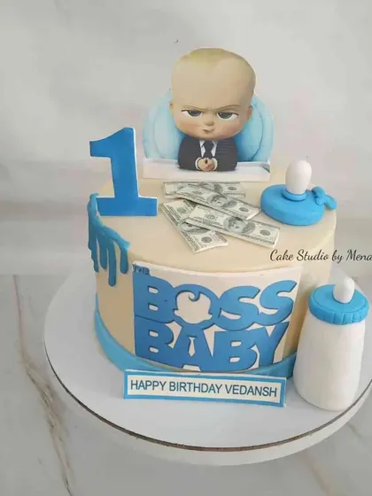 A first birthday cake for the little 'Boss Baby' of the family. This design includes the iconic character, a bottle, and stacks of edible money for a playful and cute celebration.