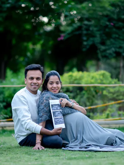 Incorporating personal items like an ultrasound scan makes your maternity photos uniquely yours. We captured this sweet moment during an outdoor session, with the couple sharing their excitement in a beautiful, natural setting.