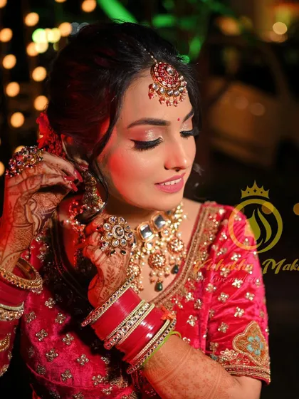 This candid shot captures the beauty of our traditional jewellery in action. The bride is seen adjusting her earring, giving a clear view of the intricate work on her oversized kundan necklace and matching pieces.
