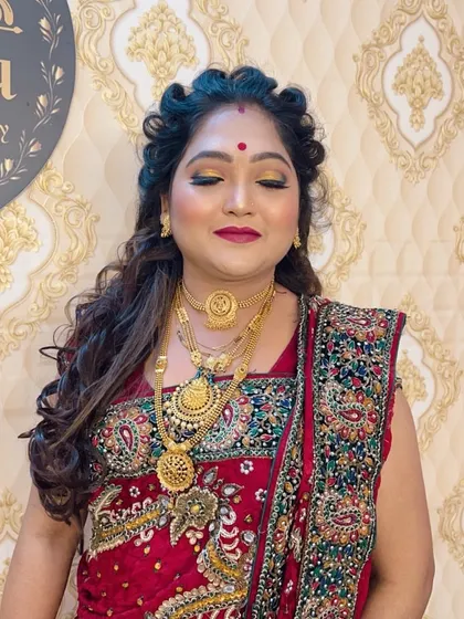 A festive look with bright gold eyeshadow and a deep red lip. This makeup is perfect for attending a wedding or a traditional party.