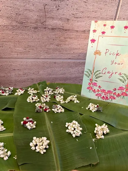 A thoughtful and traditional welcome for guests. We set up this "Pick Your Gajra" station with fresh jasmine flowers beautifully arranged on banana leaves, adding a fragrant and personal touch to the celebration.