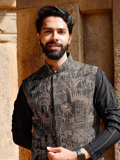 A smiling portrait in our heritage-print Nehru jacket. This piece is perfect for the man who appreciates art and wants his clothing to tell a story.