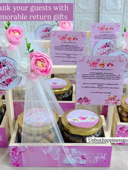 These pink-themed "It's a girl" announcement baskets are ready to go. Each one is decorated with flowers and includes a sweet poetic thank you note.