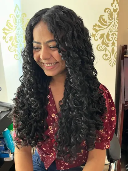Another happy client with her long, defined curly hair.