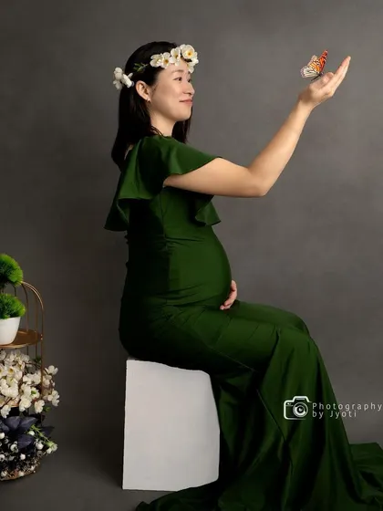 A whimsical studio shot with a butterfly prop, creating a magical moment of connection with nature.