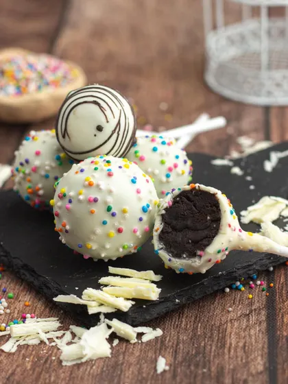 A closer look at my white chocolate cake pops. You can see the rich, fudgy cake inside, coated in a smooth layer of white chocolate and sprinkles.