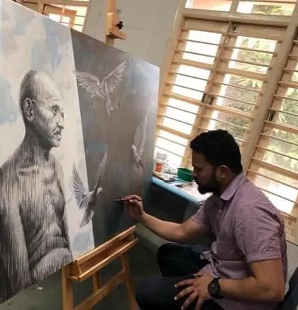 In the studio, working on the details of the Gandhiji painting. The combination of charcoal and acrylics allowed me to create both sharp details and soft atmospheric effects.