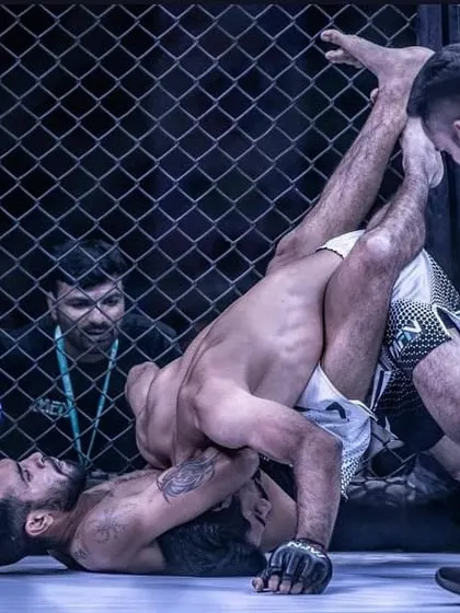 This is the reality of ground and pound in MMA. A powerful shot from MFN 3 in Mumbai, showing a fighter in a dominant position, working from the guard.
