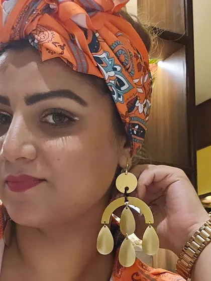 A close-up on my festival earrings. These danglers have a modern, artistic feel that perfectly complements the bohemian vibe of my outfit.