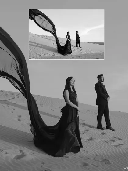 A black and white composition in the desert, where the flowing gown creates a powerful, artistic line against the vast, empty landscape.