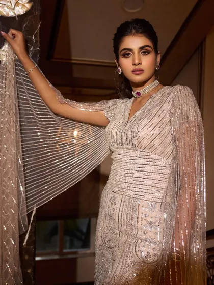 Another angle of Manisha's Falguni Shane Peacock gown, showing how the light catches the intricate beading and the flow of the cape sleeves.