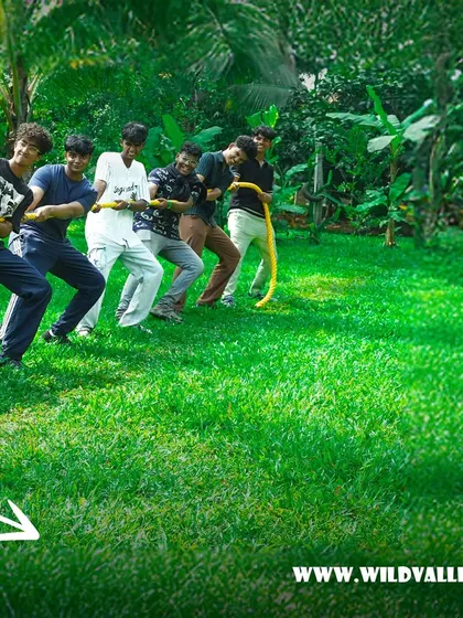 A group of friends giving their all in a tug of war match on our lush green lawns. It's a simple but incredibly effective team-building game.