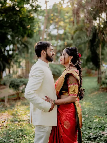 A classic, romantic pose against a backdrop of trees. The soft, diffused light of the outdoors is perfect for creating flattering and dreamy couple portraits.