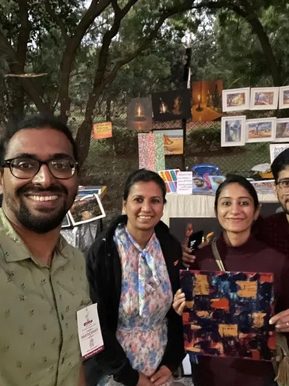A selfie with my wife and the happy new owner of her painting.