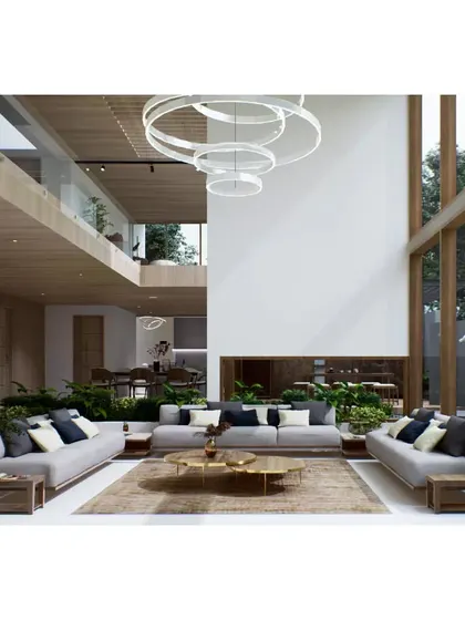 The living room of the Aakiri Residence is envisioned as a grand, double-height space filled with light. The interior design concept uses a neutral color palette, natural materials, and lush indoor planting to create a sophisticated and serene environment.