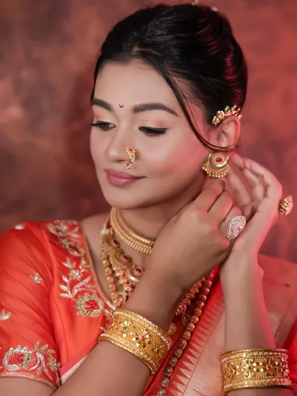 The model adjusting her earring, a perfect shot for showing details.
