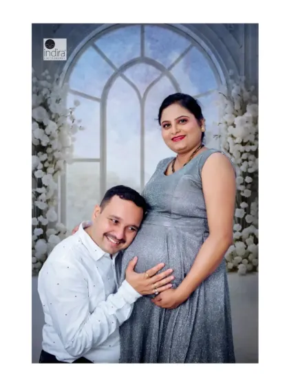 A classic maternity pose with the father-to-be listening to the baby bump, full of love and anticipation.
