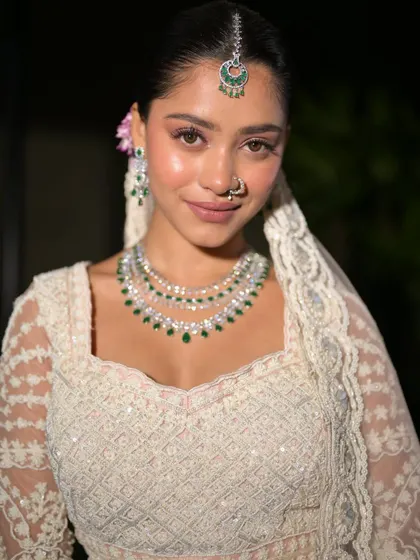 A close-up of the bride's happy face. The makeup is clean and natural, letting her radiant smile be the focus.