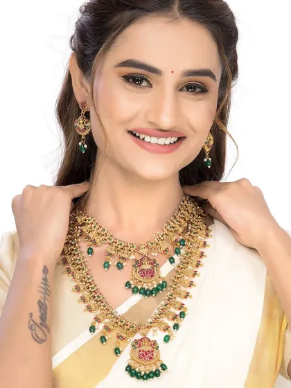 A joyful shot of the model wearing the full temple jewellery set, perfect for creating an emotional connection with the customer.