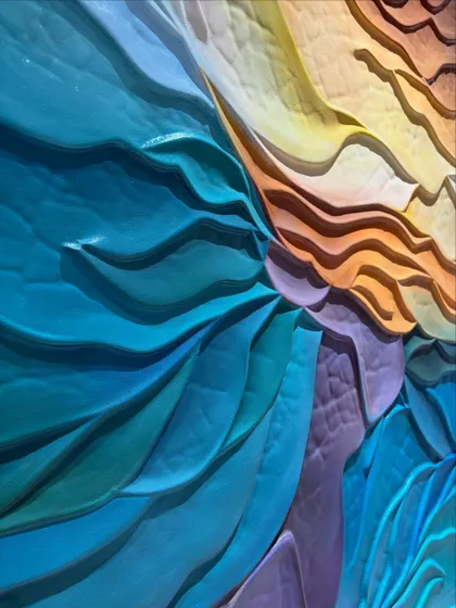 Another detailed shot of the wave sculpture, focusing on the crisp edges and the way the different colored sections interlock to create a sense of movement.