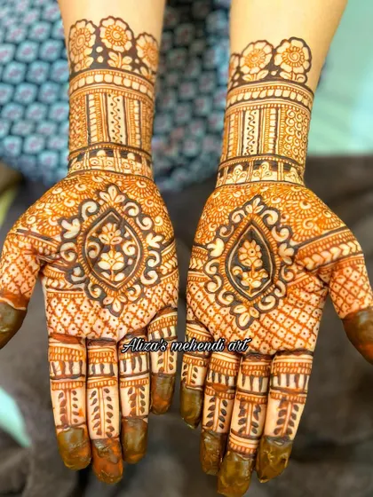 Designer hands featuring a bold, inverted pendant design. The dark-filled motif contrasts beautifully with the delicate net pattern.