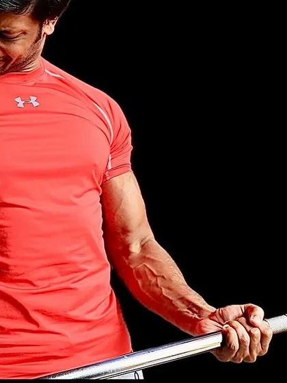 Focus on the Form. A shot of me performing a bicep curl, emphasizing proper technique and the mind-muscle connection for effective arm training.