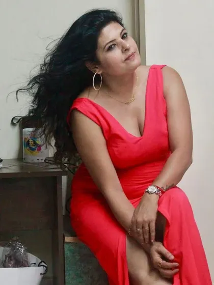 A vibrant red gown with a deep V-neck and a high slit. This is a bold, confident piece for any woman who wants to make an entrance.