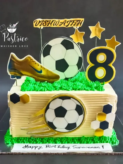 A square football-themed cake with edible prints of soccer balls and shoes, perfect for an 8th birthday.