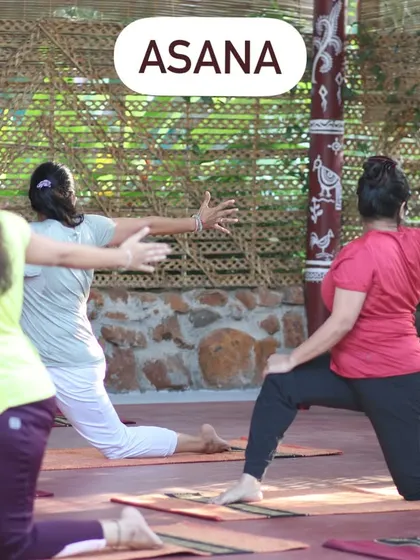 Guiding a group through asana practice in a beautiful, rustic shala.