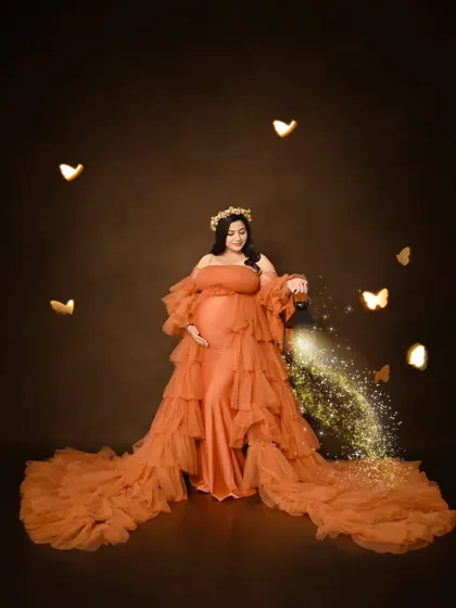 A whimsical solo portrait featuring an orange ruffled gown and a lantern prop with magical sparkling effects. This is a great example of how we add a creative touch to our photos.