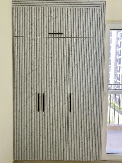 A three-shutter wardrobe with a unique textured laminate that mimics the look of fluted marble.