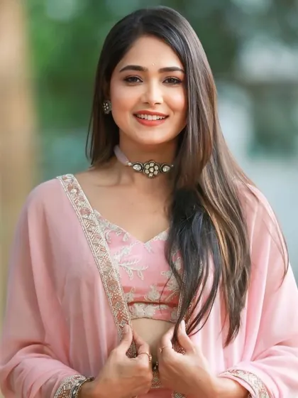 A celebrity client in a lovely pastel pink lehenga with a matching jacket, a modern and chic choice for any event.