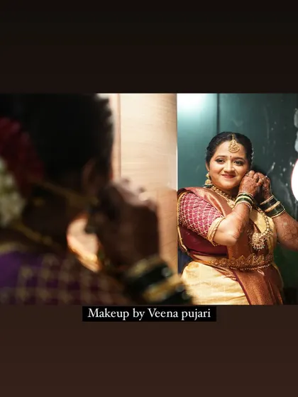 A beautiful candid moment of the bride getting ready for her muhoortham, reflecting in the mirror.