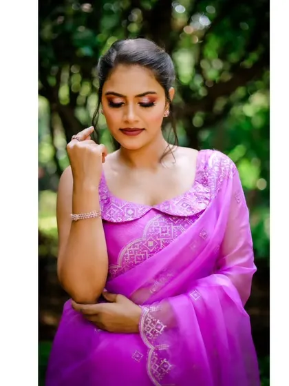 A beautiful portrait of a model wearing the lavender organza saree, showcasing the delicate embroidery.