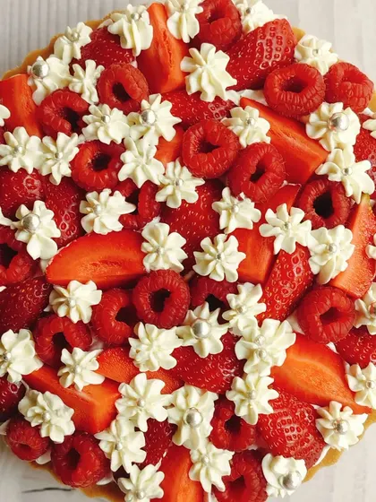 A top-down view of the Strawberry and Raspberry Cheesecake Tart, showcasing the beautiful pattern of berries and cream.