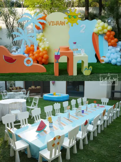 A fun and sunny summer pool party theme for Vihaan's 2nd birthday. The outdoor setup included a kids' dining table, a small pool, and bright, beach-themed props like surfboards and palm trees.